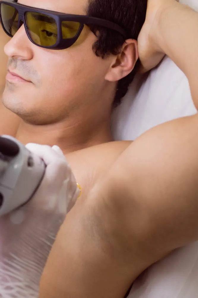 dermatologist-performing-laser-hair-removal-male-patient